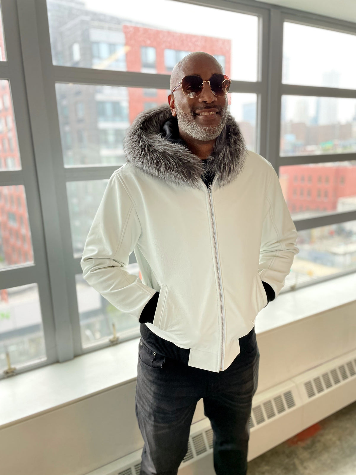 Heavyweight lambskin leather jacket with fox fur trimmed hood 